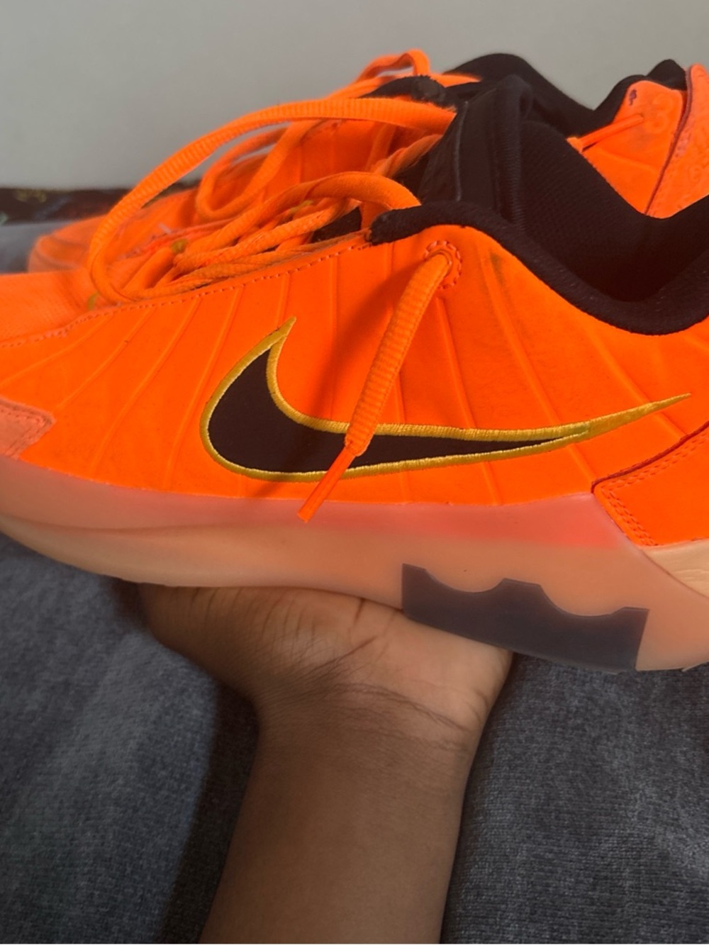 Nike Orange Low-Top Sneakers with Black and Gold Swoosh